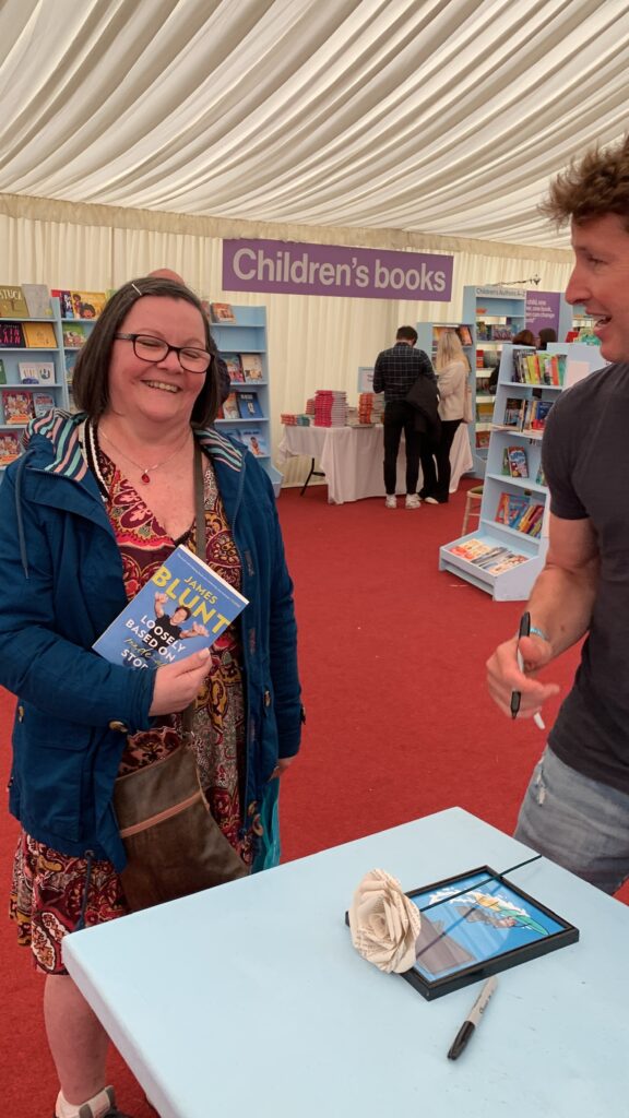 Several photos of Hilra and James Blunt, while he signed his book for her.